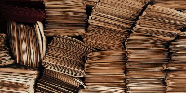 A detailed view of neatly stacked brown envelopes