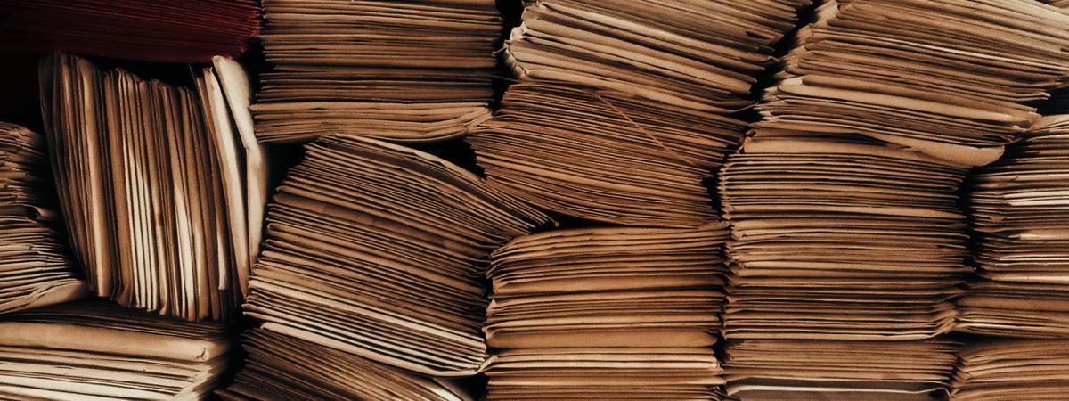 A detailed view of neatly stacked brown envelopes