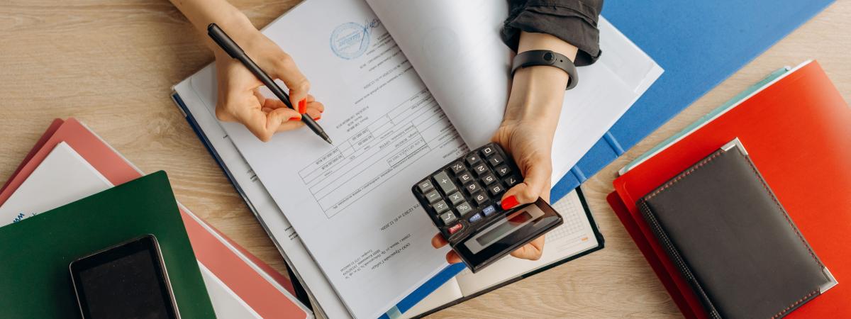 Person sat down with calculator 